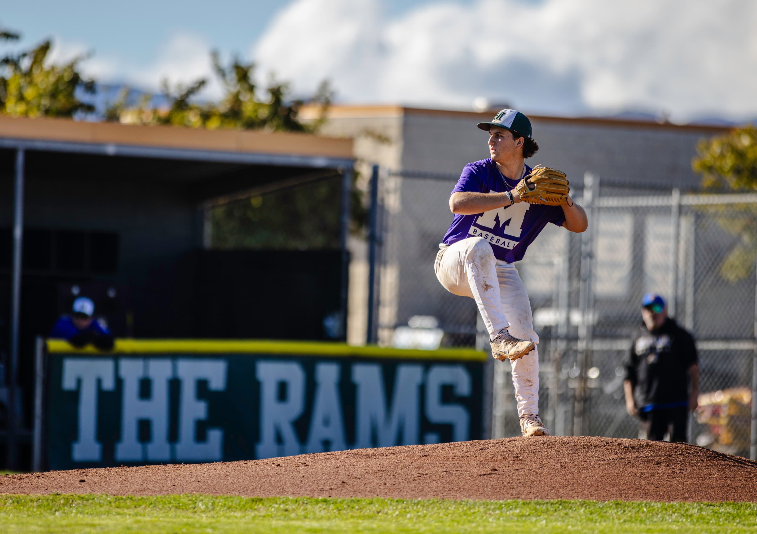 Pitcher mid-windup on the mound