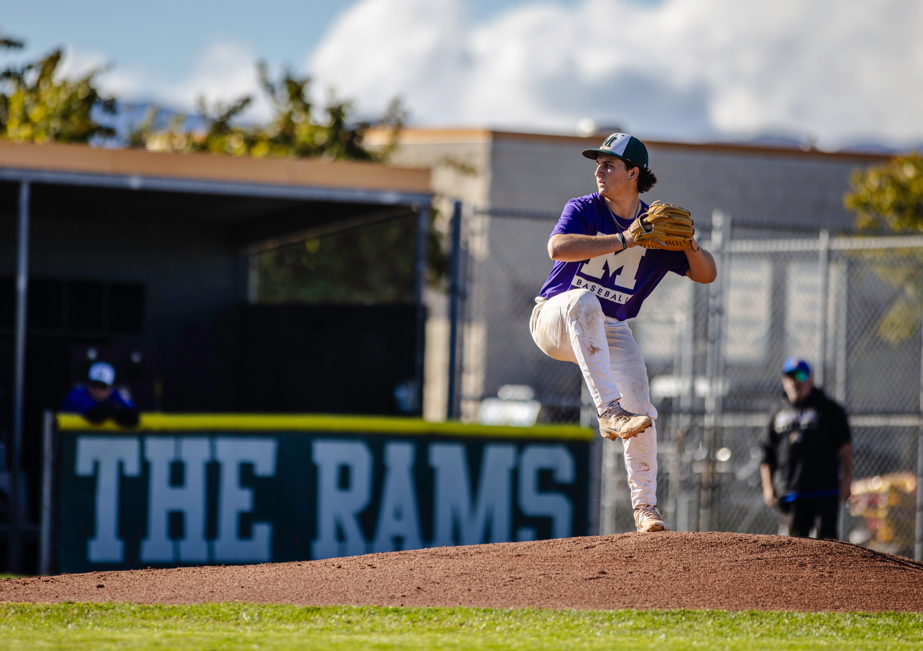 Pitcher mid-windup on the mound