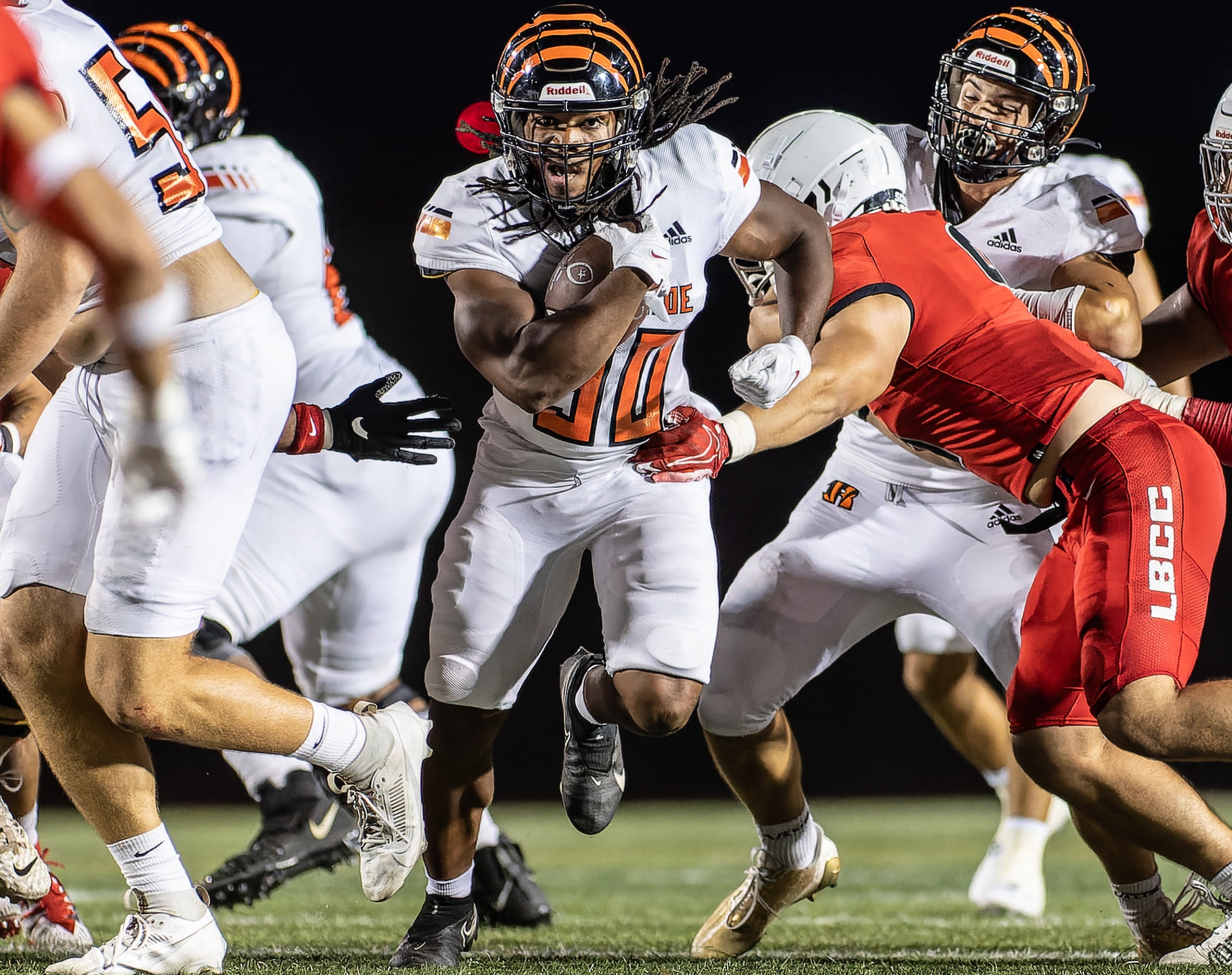 Football players under stadium lights in the fourth quarter