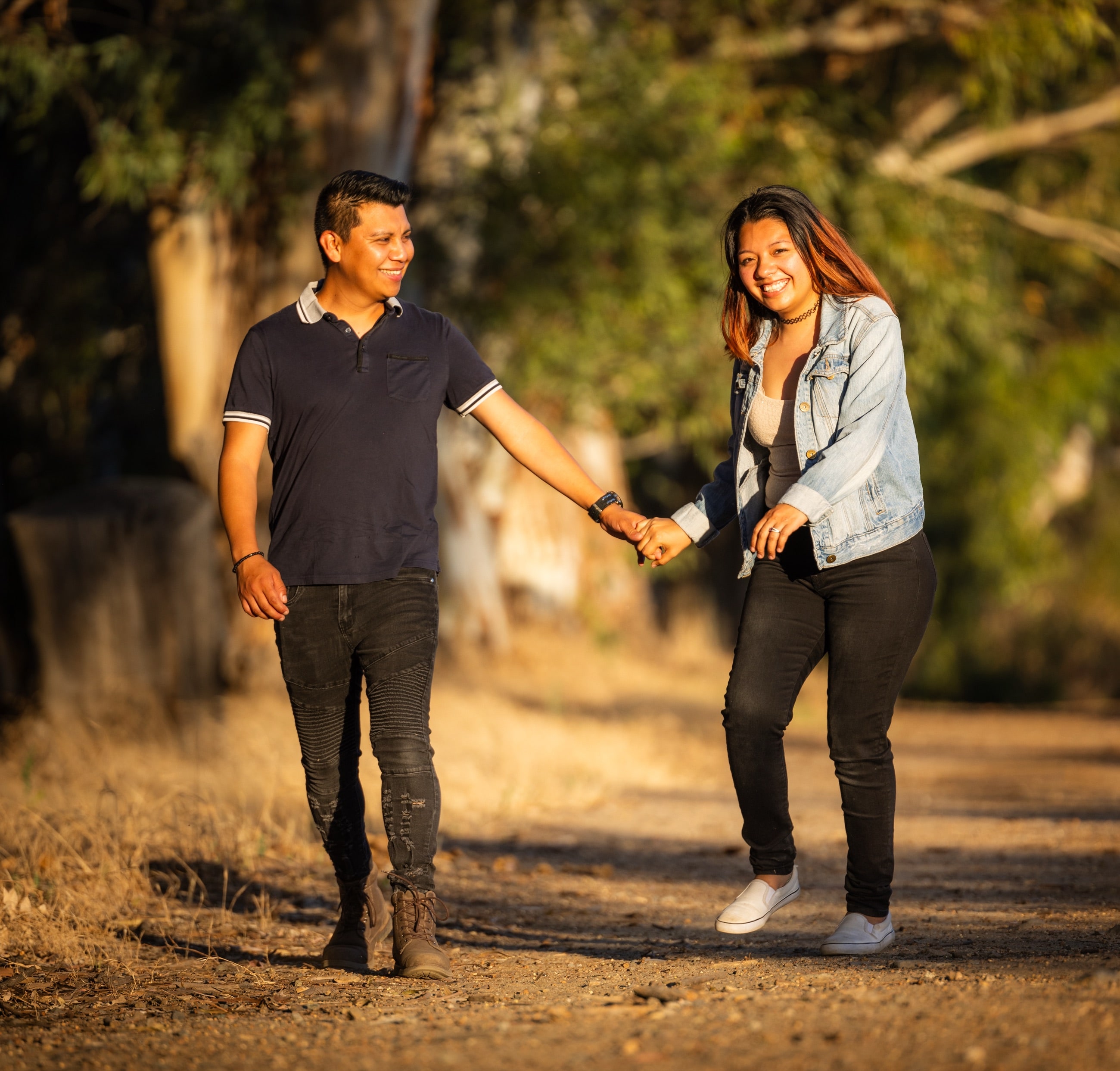 Engaged couple on a golden-hour path