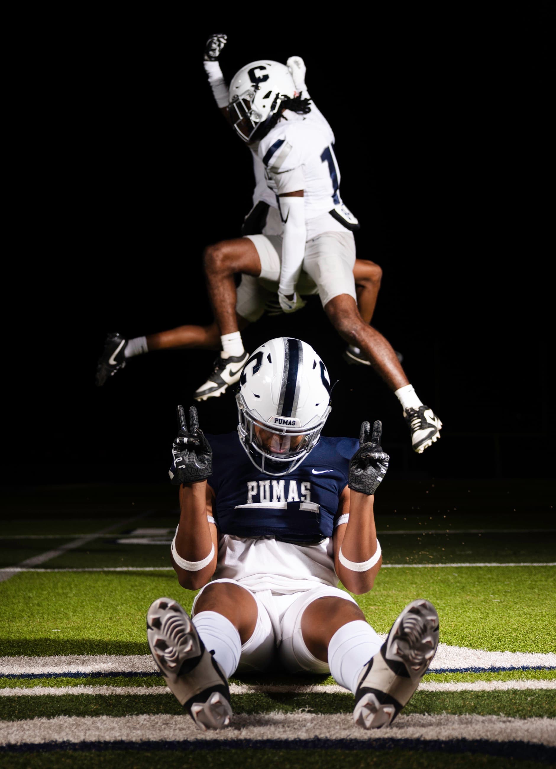 Player celebrating a touchdown with teammates